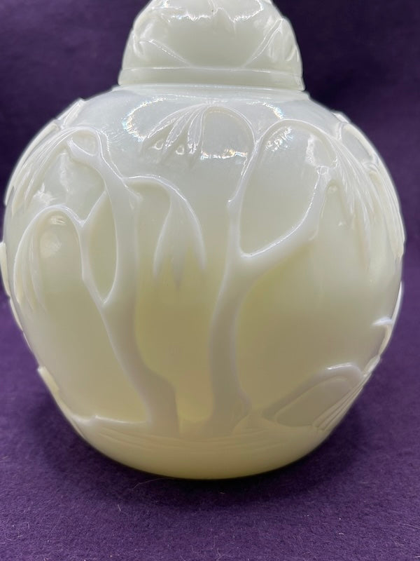 Carved Hetian White Jade ginger jar featuring intricate floral designs and elegant craftsmanship.