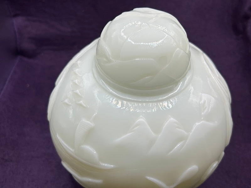 Top view of a carved Chinese Hetian white jade ginger jar with intricate floral details and a smooth finish.