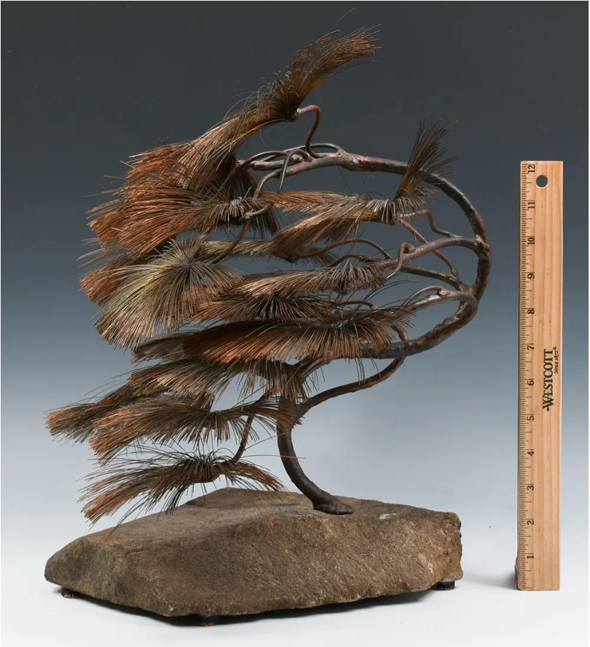 Brutalist bonsai sculpture by John Steck with copper wire fronds on a natural stone base, showcasing modern art design.